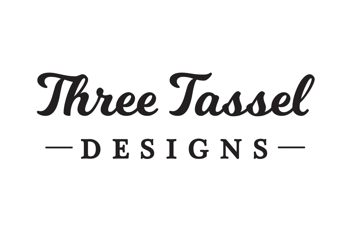 Logo of 'Three Tassel Designs' on a gray background